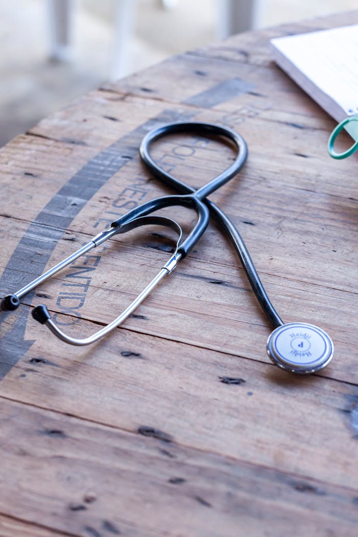 Close-up of a stethoscope on a rustic wooden table symbolizing healthcare and medical practice.