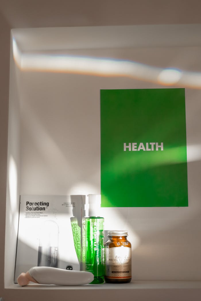 Skincare products arranged with green 'Health' poster on white background.