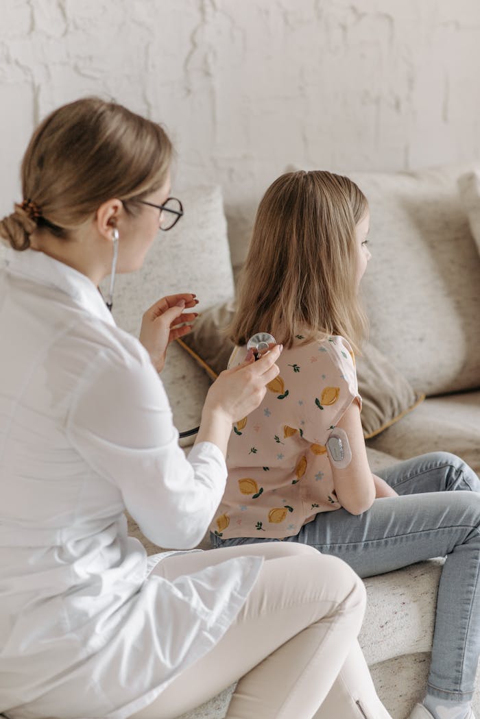 Doctor conducting a health check on a young girl managing diabetes at home.