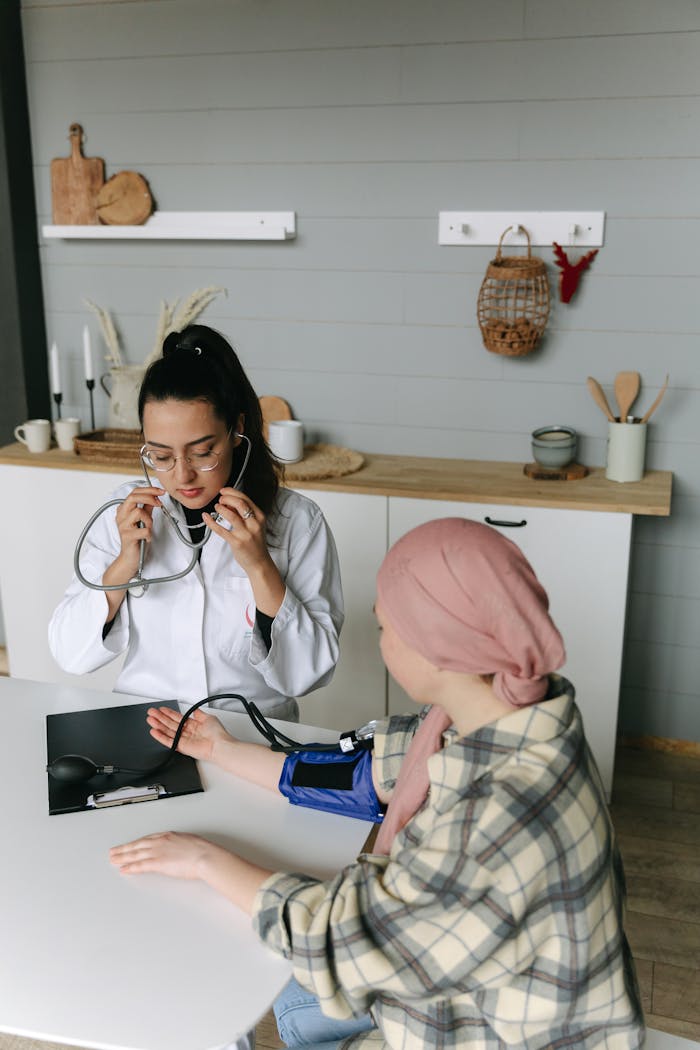 A doctor checks a patient's blood pressure in a medical setting with caring attention.