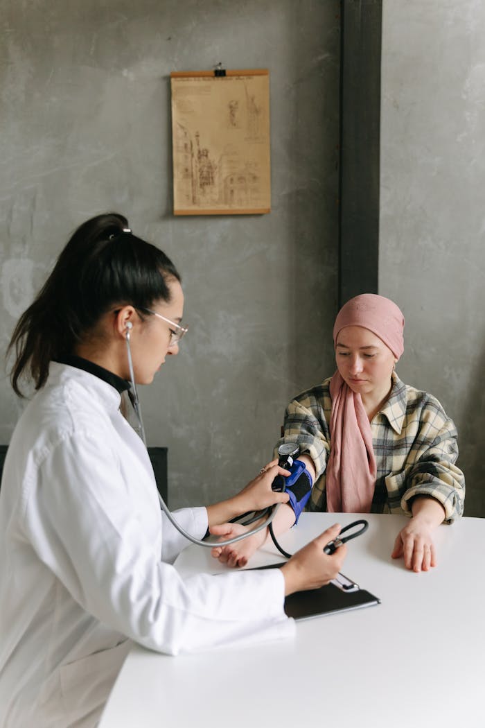 Doctor checks patient's blood pressure, emphasizing care and support.